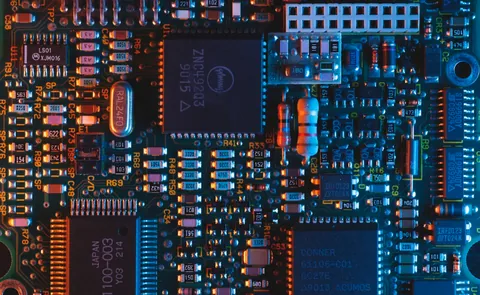 Close-up of a populated industrial circuit board with capacitors and connectors